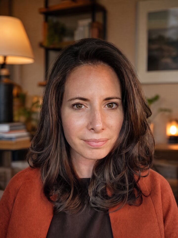 Ashley, founder of Steeped Psychotherapy, with shoulder-length brown hair and a rust-coloured cardigan.